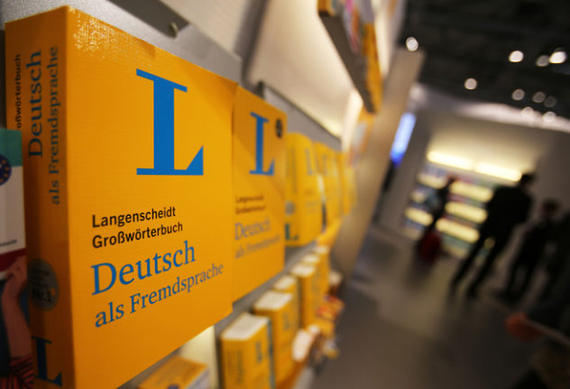 Dictionaries for German as a foreign language from Langenscheidt on a shelf in a book shop.