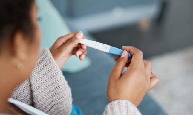 A woman takes a pregnancy test.