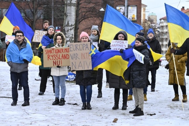 Protestors hold banners and Ukrainians flag outside Russia's embassy in a the days leading up to the invasion.