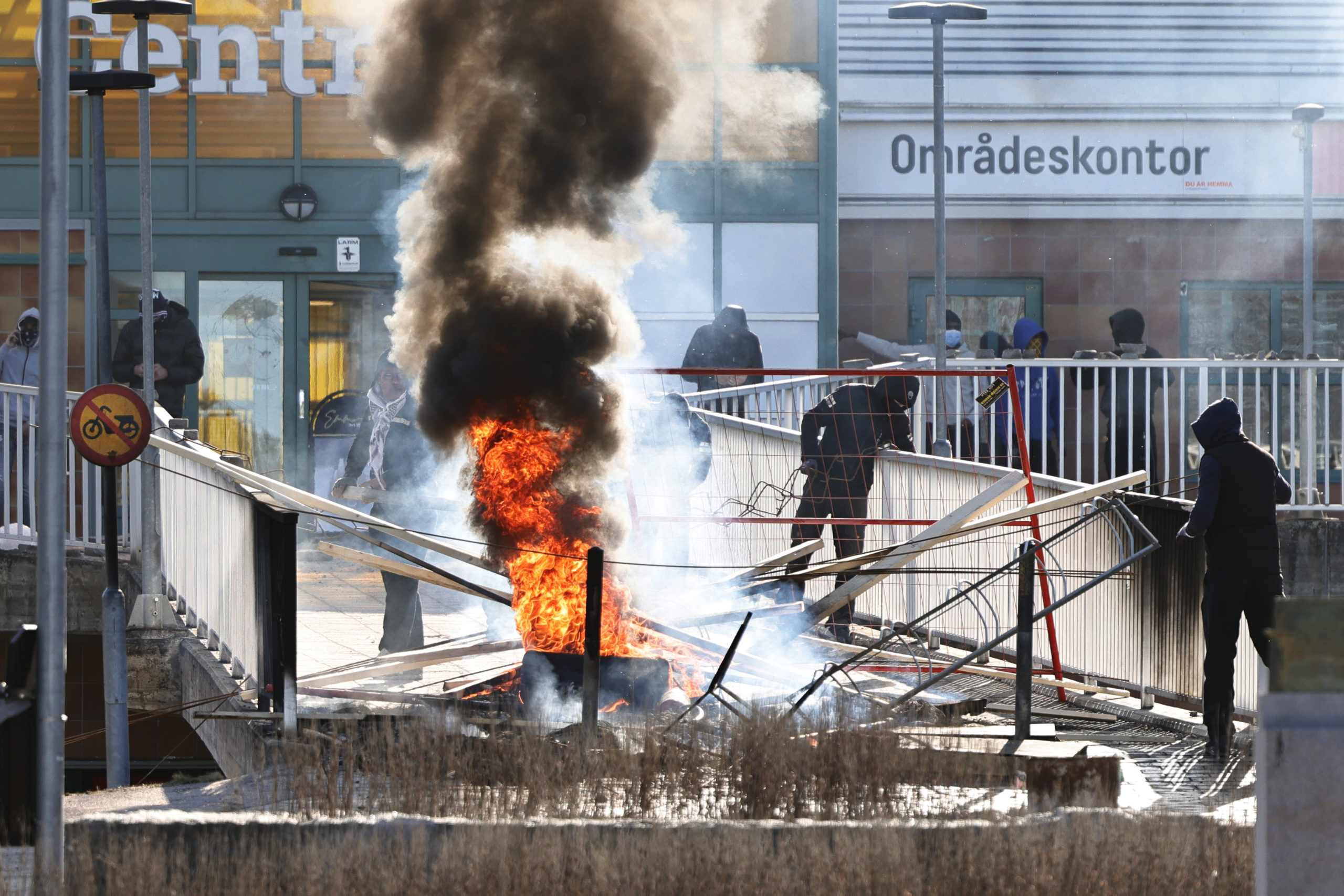  People make a barricade with burnt car tires and other objects at Ringdansen center, in connection with riots in Navestad in Norrköping on Easter day