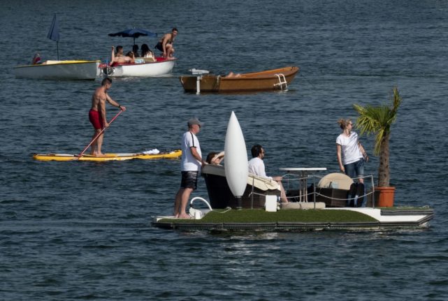 People make their way in peddal boats on the Old Danube (Alte Donnau), a subsidiary of the Danube river, in Vienna, Austria.