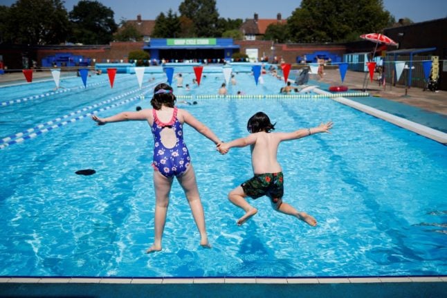 Children jump into a swimming pool