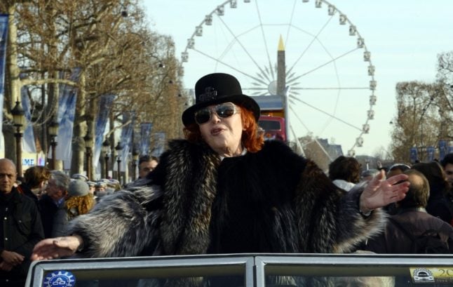 n this file photo taken on January 01, 2015 French singer, actress and businesswoman Regine waves to the crowds during a parade, along the Champs-Elysees in Paris to celebrate the New Year.