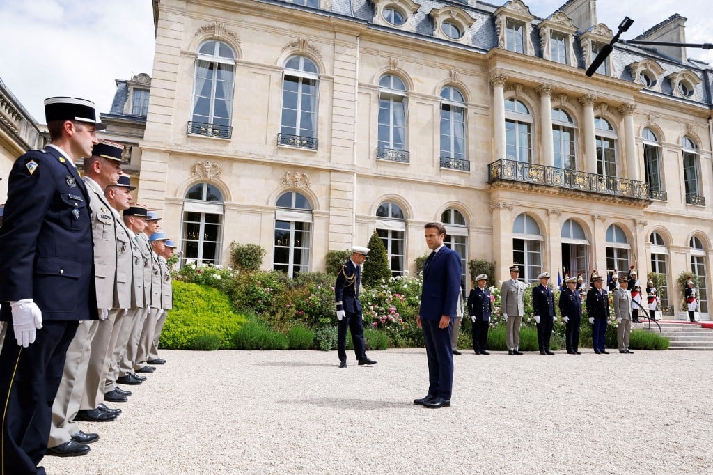 President Emmanuel Macron reviews the troops in the gardens of the Elysee palace