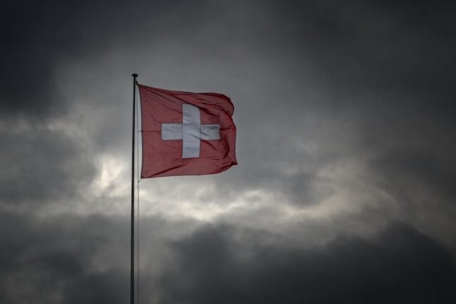 The Swiss national flag blows in the wind