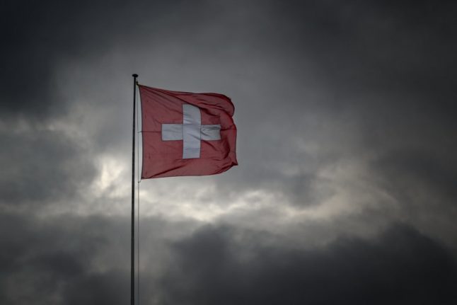 The Swiss national flag blows in the wind