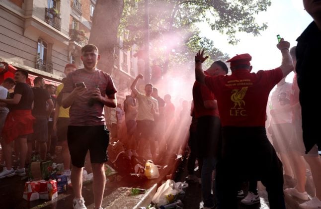 Liverpool FC's supporters dance and drink near a bar in Paris on May 27, 2022, on the eve of the Champions League football match final between Liverpool and Real Madrid.