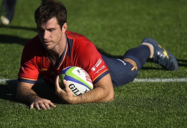 Spanish rugby player Ignacio Contardi scores a try.