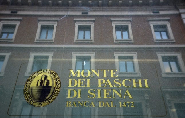The logo of the Monte dei Paschi di Siena bank is seen on the window of a branch in downtown Rome.