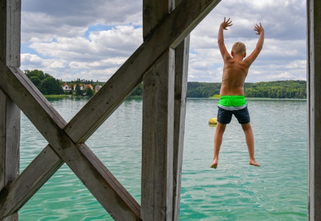 A boy jumps from a tower at the lido in Buckow into the water of Schermützelsee.