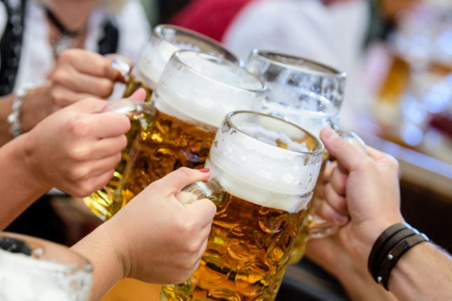 People drink beer at Oktoberfest in Munich in 2019.