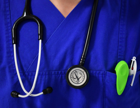 A doctor in Germany wears a stethoscope.