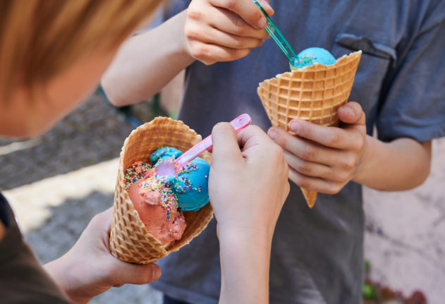 Children eat ice cream in Berlin.