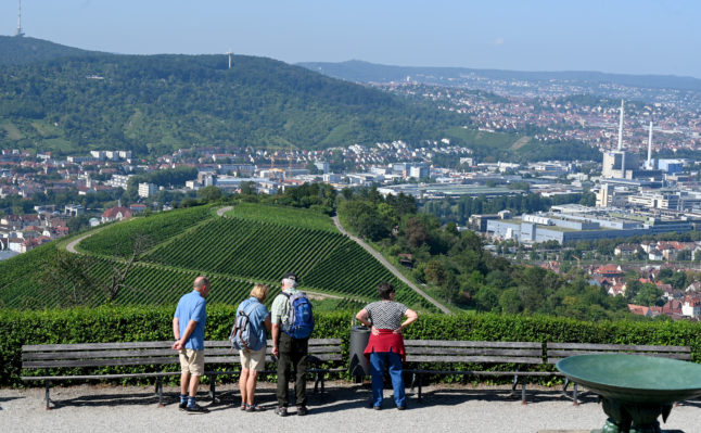 Hikers in Stuttgart look out from Württemberg onto vineyards and the company grounds of the car manufacturer Mercedes-Benz.