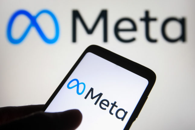 The Meta logo on a smartphone and a computer monitor.