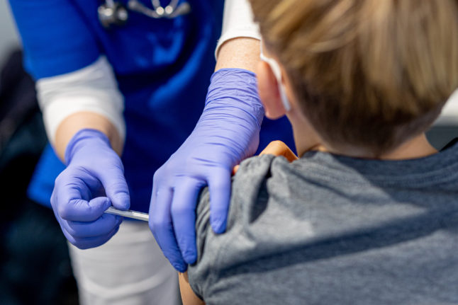 A young person receives a Covid vaccination in Germany.