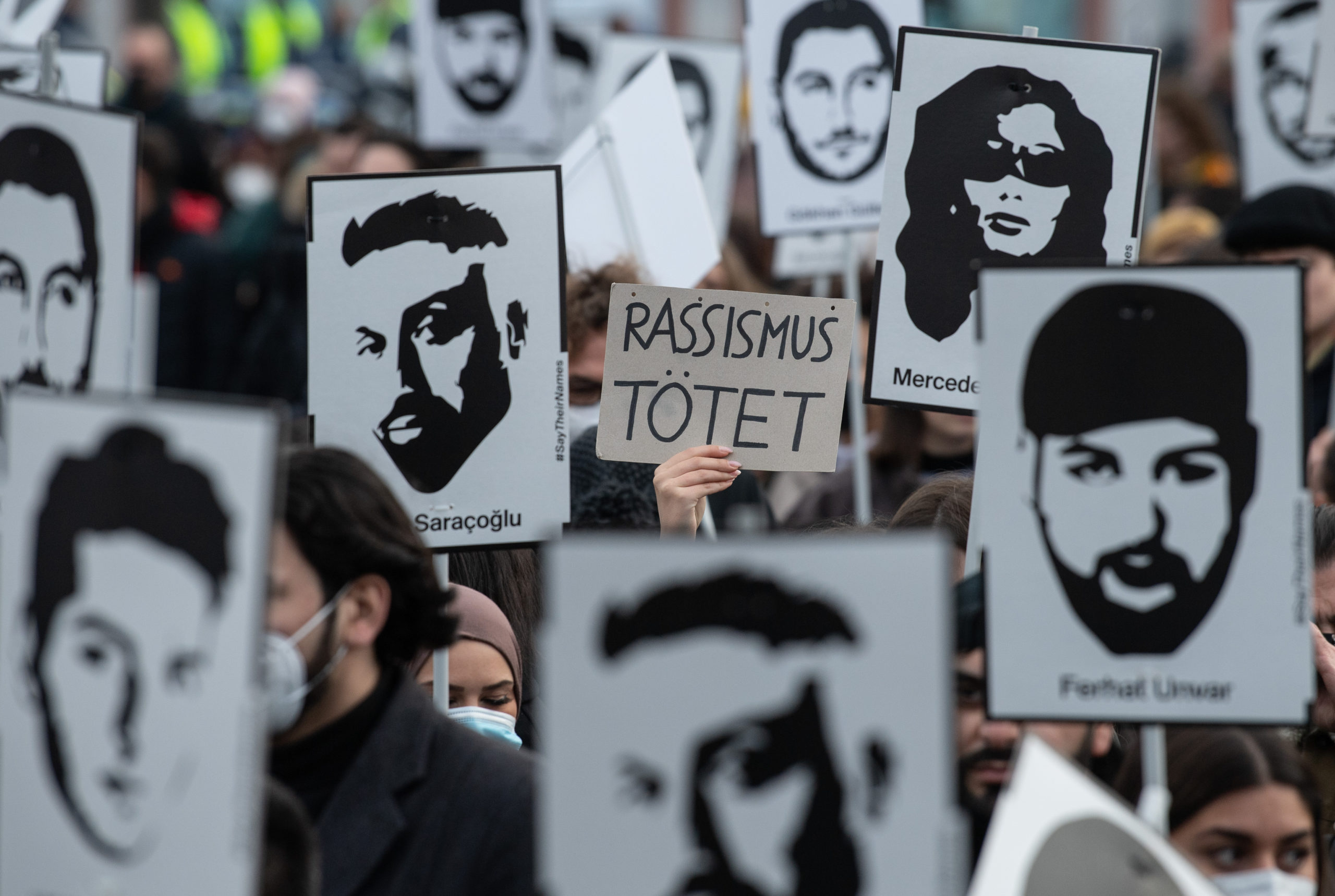 A sign reads 'racism kills' at a memorial event in February 2022 for the victims of the Hanau racist attacks in 2020. 