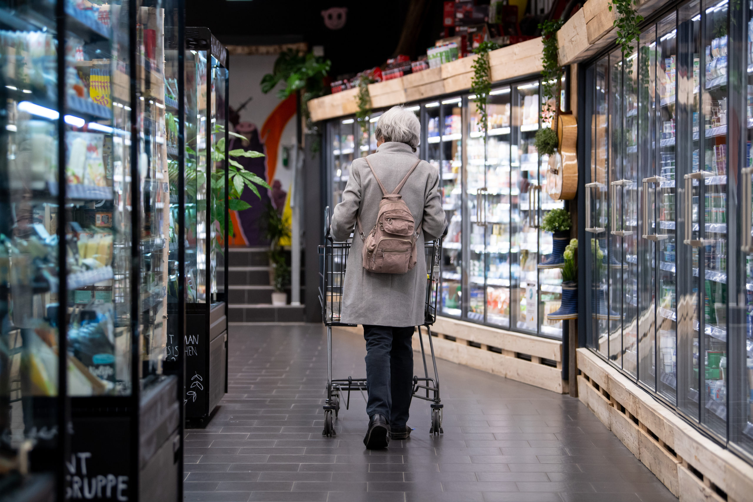 A shopper walks round a supermarket in Neubiberg, Bavaria. 