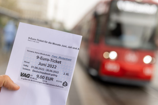 An employee of the VAG (Verkehrs-Aktiengesellschaft Nürnberg) presents a printed draft of the €9 ticket.