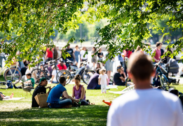 People enjoy the sunny weather in a Frankfurt park.