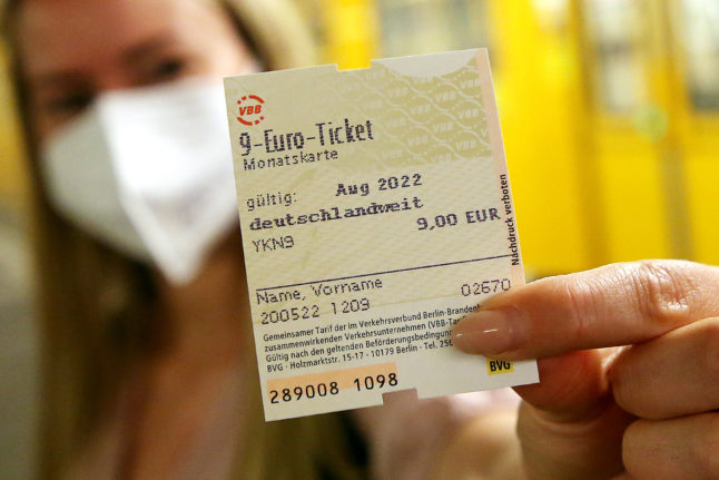 A rail passenger holds the €9 monthly ticket in Berlin on Friday.