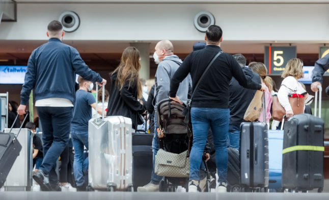 People arrive at Hamburg airport.