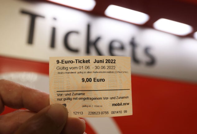 A passenger holds an example of the €9 ticket in Cologne. 