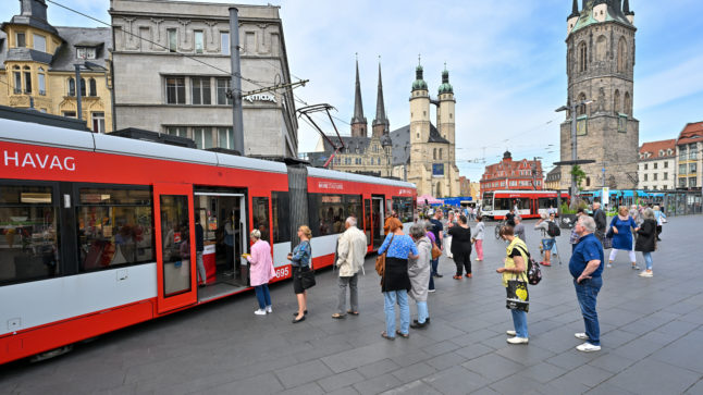 Passengers queue at an information tram to buy the 9-Euro-Ticket in Halle.