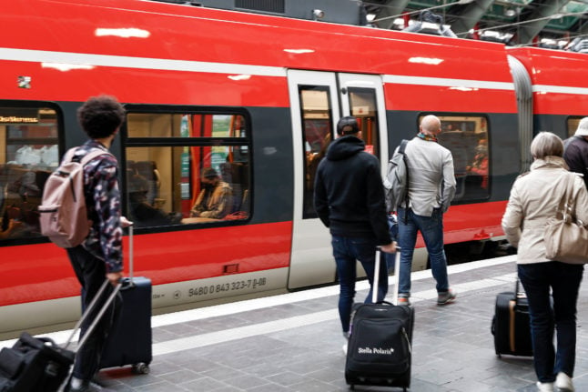 Travellers queue for a train at Berlin's Ostbahnhof. People are expecting crowded trains during the cheap transport offer.