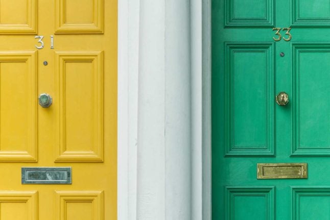 Close up pictures of colourful doors. A new study shows renting can be cheaper than buying in Switzerland. Photo by Christian Stahl on Unsplash
