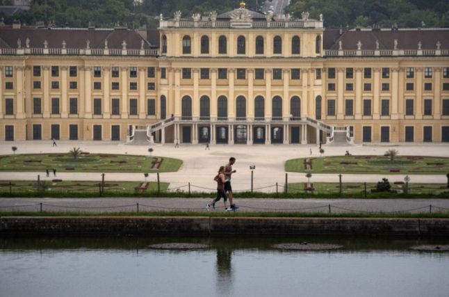 Runners jog in a garden of Schönbrunn Palace, the main summer residence of the Habsburg rulers.