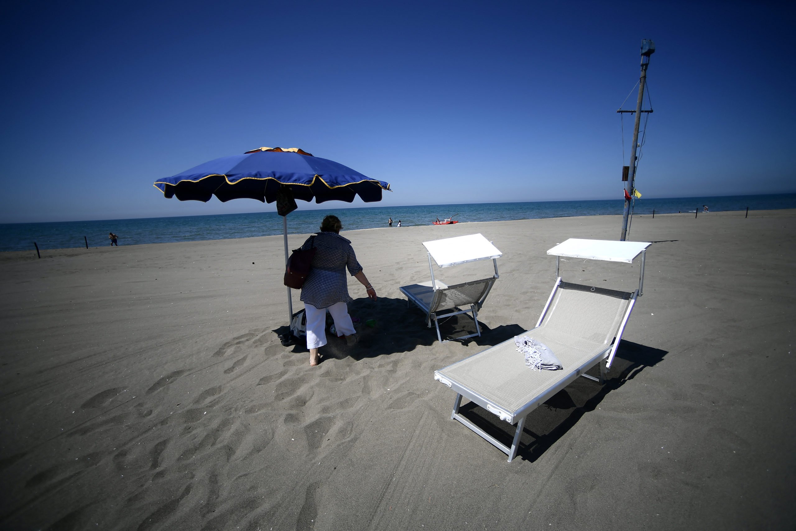 People enjoy a private beach in Fregene, northwest of Rome, on May 13, 2022. 