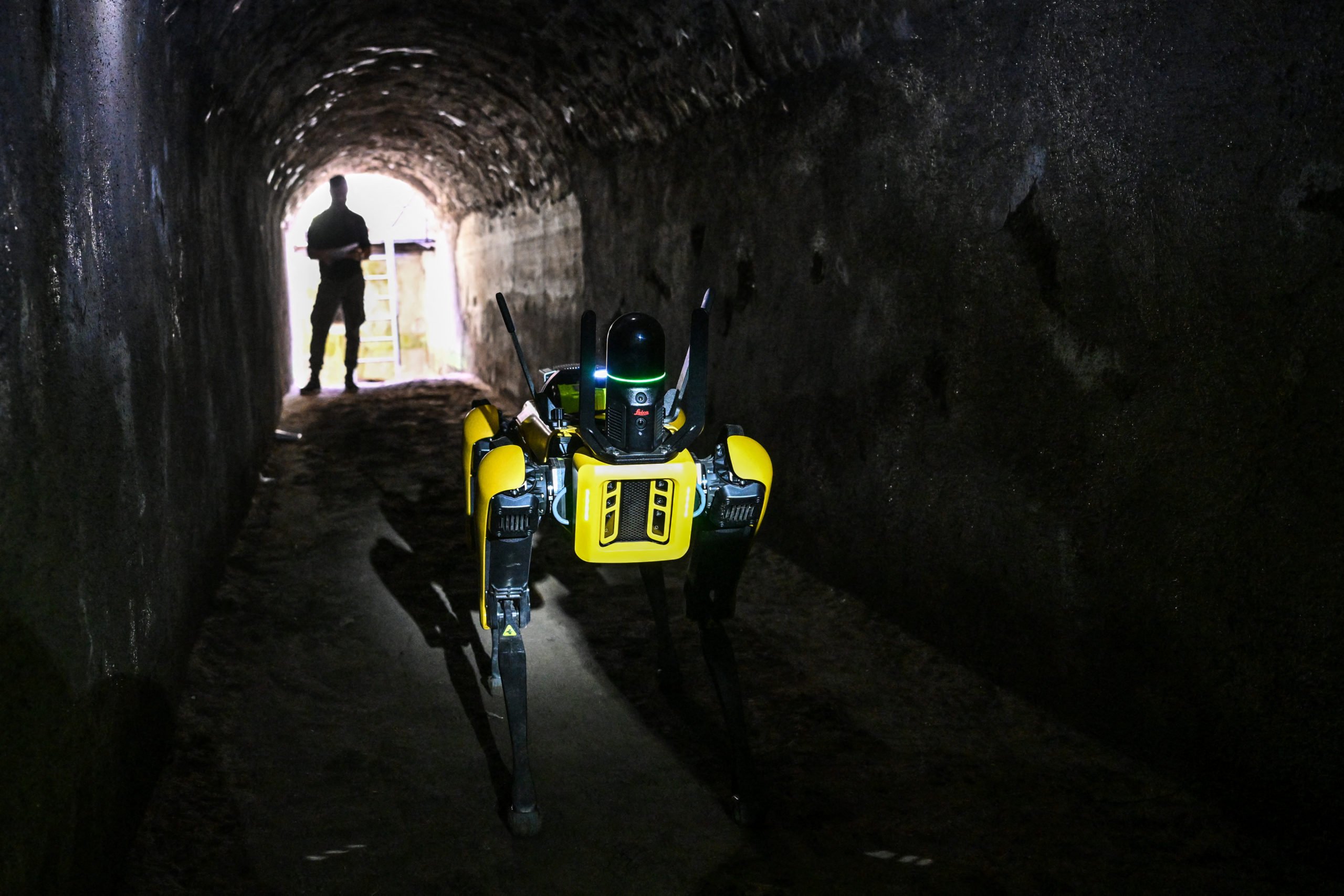 Spot is driven through an underground tunnel by a technician. 