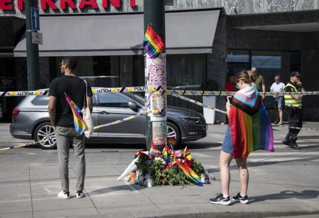 A woman laying flowers at a memorial near the scene of a shooting in Oslo.