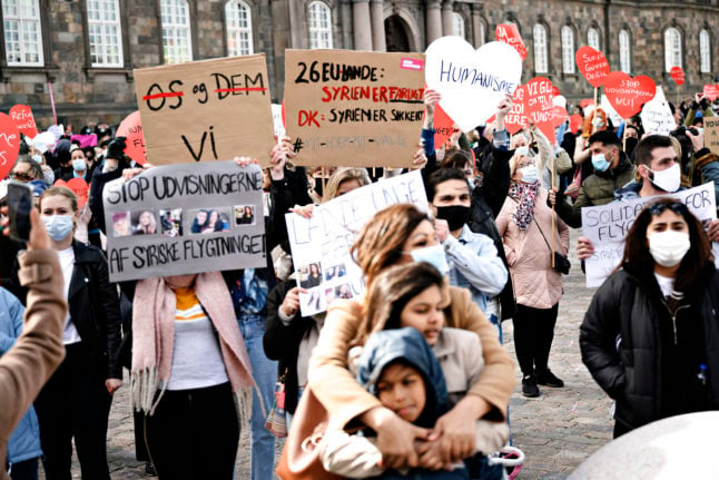 People in Denmark protest in April 2021 against repatriation of Syrian refugees.
