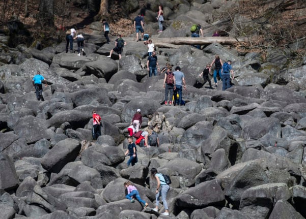 Hundreds of visitors climb over the rocks of the Felsenmeer , which is a popular attraction in the Odenwald.