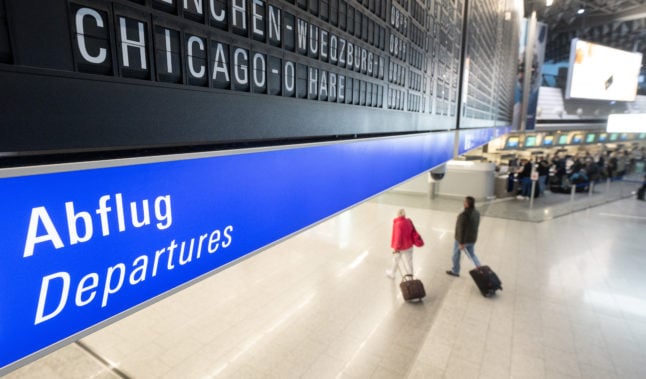 A flight to Chicago shown on a departure board in Frankfurt.