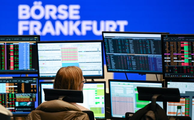 A trader from ICF Bank looks at her monitors at her workplace on the floor of the Frankfurt Stock Exchange. 