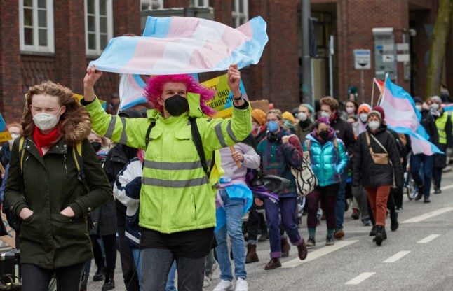 A participant holds a transgender flag at a demonstration in Hamburg on International Transgender Day of Visibility on March 31st.