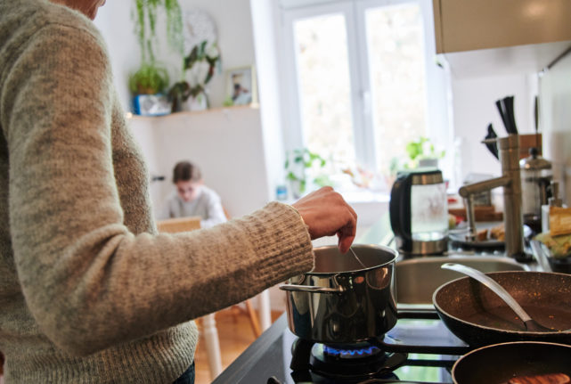 Woman cooks on gas stove