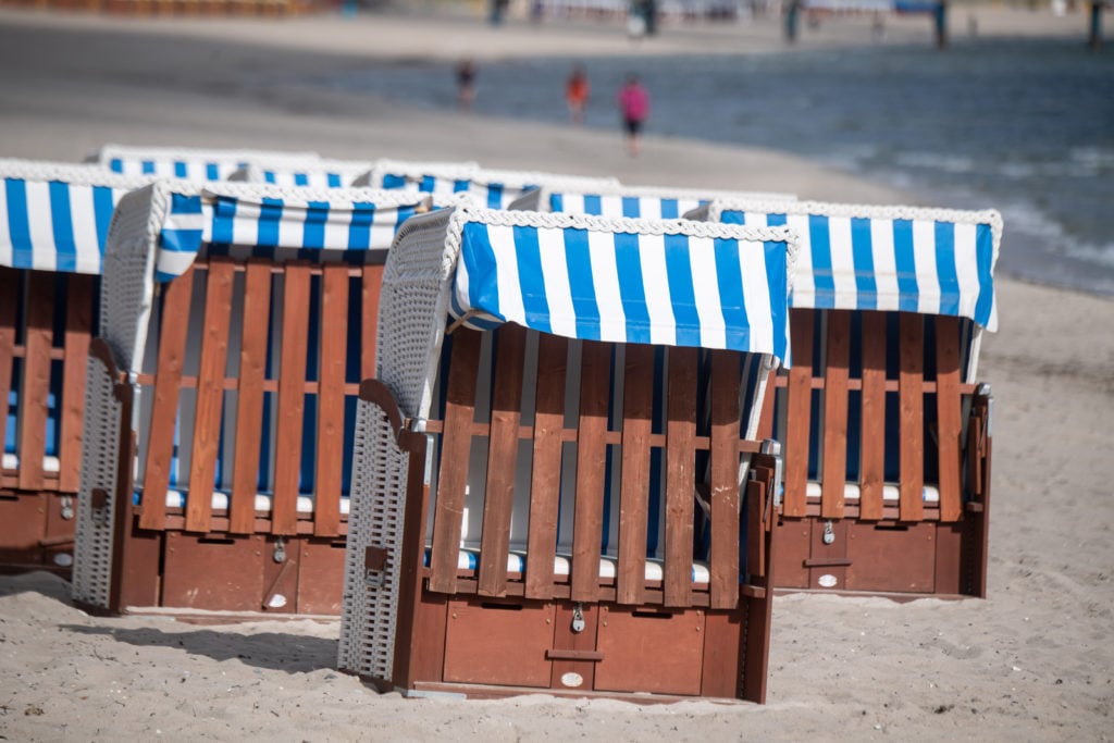 Beach chairs stand in sunny weather on the beach in the Baltic resort of Binz on the island of Rügen. 