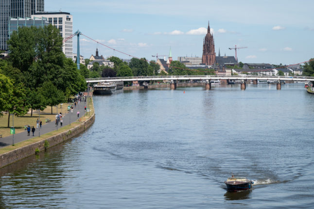 A boat sails across the Main river in Frankfurt. 