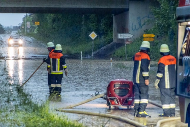 Firefighters pump water from a flooded street in Neumarkt-Sankt Veit, Bavaria.