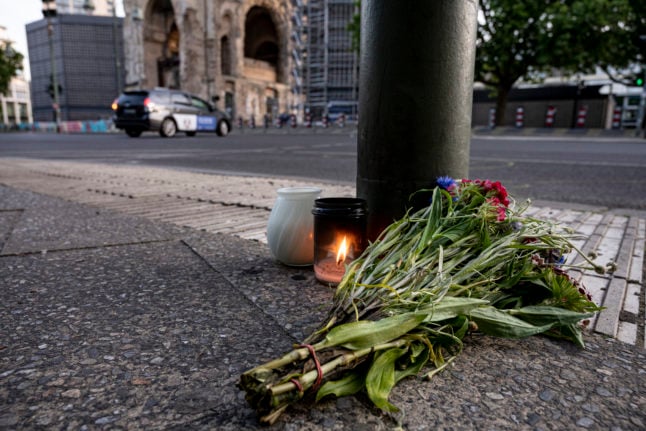 Tributes lie on the pavement on Berlin's Tauentzienstraße where a car was driven into a group of people, resulting in the death of a teacher.