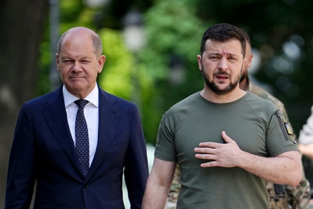 German Chancellor Olaf Scholz walks with Ukrainian President Volodymyr Zelensky in Kyiv on Thursday.