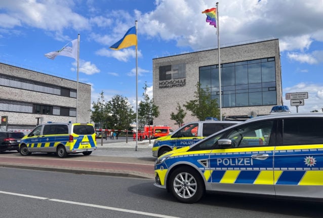 Police emergency vehicles parked in front of the Hamm-Lippstadt University of Applied Sciences building where a 34-year-old man attacked several people with a knife and injured four people on 10th June 2022.