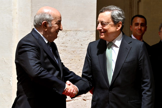Algerian President Abdelmadjid Tebboune shakes hands with Italian PM Mario Draghi (R) prior to their meeting at Chigi Palace, in Rome, on May 26, 2022.