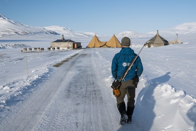 Pictured is someone with a rifle in Svalbard.