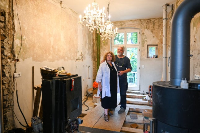 Iris Muenn-Buschow und her husband Michael Buschow (R), organisers of the demo 'the Ahr valley stands up', at their destroyed house in Bad Neuenahr-Ahrweiler in Rhineland-Palatinate, western Germany, almost one year after the region was devastated by floods.