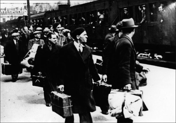 photo taken in May, 1941 shows Jewish deportees getting off the train in Pithiviers